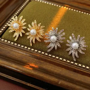 Elegant sunflower pearl stud earrings with sparkling cubic zirconia in gold and silver finish