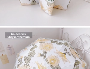Detail of white umbrella with yellow wild chrysanthemum patterns and decorative border