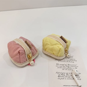 Quilted heart-shaped cotton pouch with golden pearl zipper detail for earbuds storage