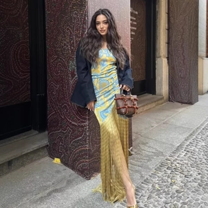 Women's yellow and blue paisley print tassel dress with a navy blazer and beaded handbag
