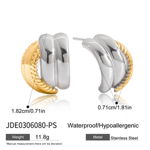 Detail view of 18K gold and silver two-tone C-shape earrings with twisted texture and mirror polish