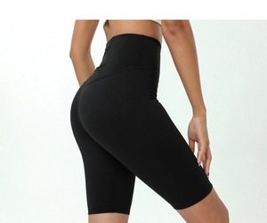 Detail view of high-waisted black yoga shorts with crossed back waistband detail
