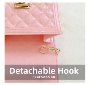 Detail of pink jelly bag showing gold metal detachable hook and diamond lattice texture