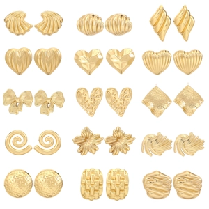 Macro shot of a 15-pair gold earring set featuring textured hearts and flowers