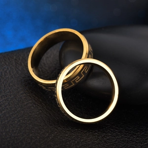 Golden titanium steel couple rings with vintage Greek meander pattern on black stones