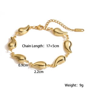 Macro view of gold-plated stainless steel teardrop links with lobster clasp detail