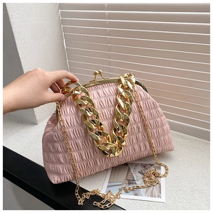 Close-up of pink pleated shell handbag featuring gold chunky chain and fine shoulder strap