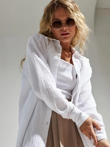 Close-up of white cotton crepe long sleeve shirt texture and loose casual fit design