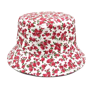 Close-up of the delicate red floral pattern on a white cotton sun bucket hat fabric