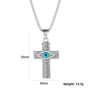 Detail view of steel cross pendant with evil eye motif and wave pattern texture