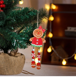 Close-up of wooden gingerbread girl Christmas ornament with beaded legs on a tree