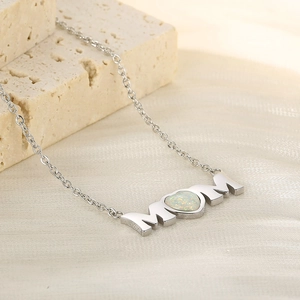 Macro view of silver MOM necklace featuring a heart-shaped opal stone inlay