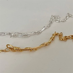 Detail of twisted wire design on S925 sterling silver bracelets in gold and silver