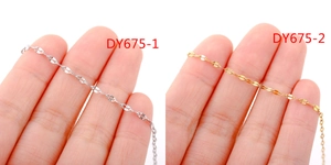 Macro detail of delicate 18k gold plated stainless steel lip chains on fingers