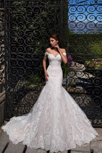 Close-up of intricate lace embroidery and floral patterns on the mermaid wedding dress tail