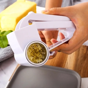 Manual cheese grater detail showing white rotary shredder with stainless steel drum