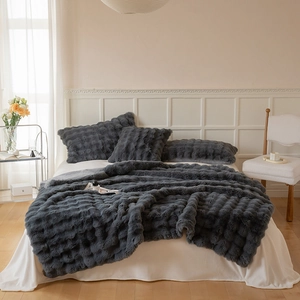 Detail of dark gray faux rabbit fur texture on a thick double-layer luxury blanket