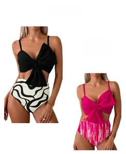Detail of high-waisted bikini bottoms with striped patterns and large bow-knot crop tops