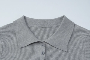 Close-up of a grey ribbed knit polo collar and button placket of a casual dress
