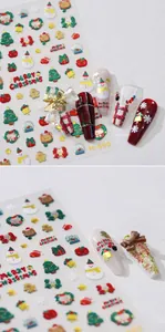 Macro detail of 3D embossed Christmas nail stickers featuring snowman and tree patterns