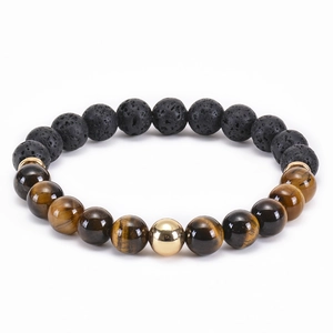 Elastic beaded bracelet with black lava stone and tiger eye beads featuring gold metal accents