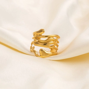 Detail of irregular hollow wave design on 18K gold-plated stainless steel wide band ring