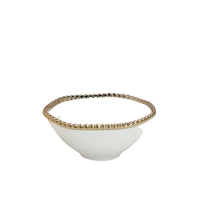 White ceramic bowl with elegant gold beaded rim and minimalist studio background