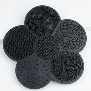 Flower-shaped black silicone makeup brush cleaning mat with multi-texture suction pads