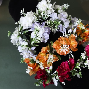 Detailed view of colorful handmade artificial rose floral headbands on black background