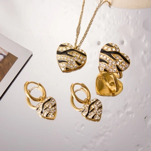 Golden heart jewelry set with zebra enamel and sparkling crystals on mirror