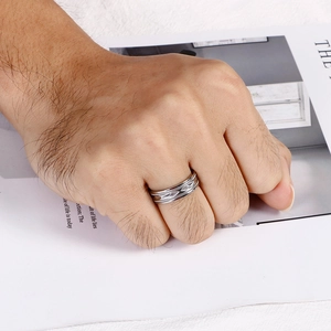 Macro detail of men's silver stainless steel ring with geometric diamond engraving
