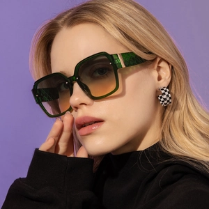 Detail of square gradient sunglasses with green translucent frames and woven textured temples