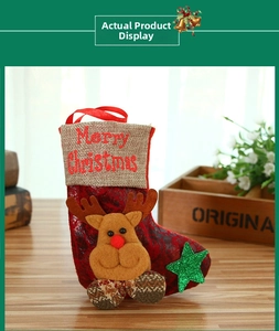 Detail of a vintage Christmas stocking with reindeer plush and Merry Christmas print