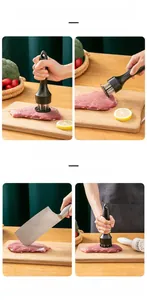 Detail of stainless steel meat tenderizer needles pressing into fresh beef on wood