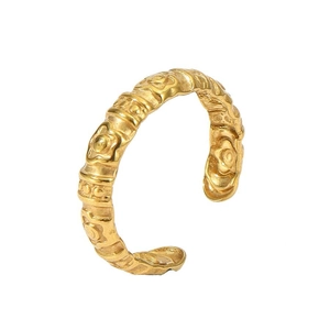 Macro shot of 18k gold plated open ring featuring embossed floral pattern detailing