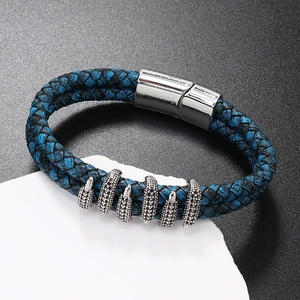Detail showing blue and black braided leather bracelet with silver rings and magnetic clasp