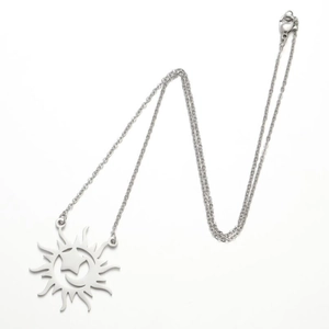 Close-up of bohemian silver sunburst pendant with crescent moon and star on fine chain