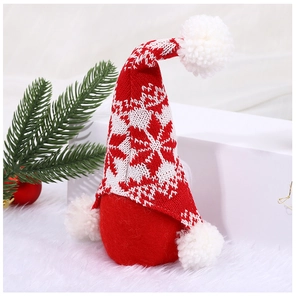 Detail of red Christmas gnome doll with star pattern knit hat and white plush beard