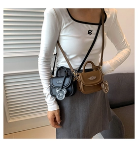 Mini PU leather crossbody bags in black and brown with metal decor and bear charms