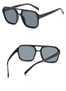 Detail view of black square sunglasses with double-bridge frame and grey lenses