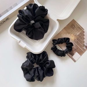 Three pieces of black satin scrunchies in two sizes with elegant silky finish