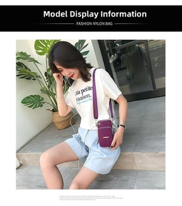 Detail of purple nylon crossbody phone bag featuring gold hardware and adjustable strap