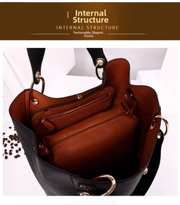 Detail view of large tote bag interior with black pebble leather and brown lining