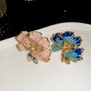 Detailed back view of flower brooches showing the secure safety pin closure mechanism