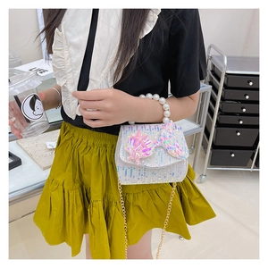 Close-up of kids sequin shell purse with mermaid tail detail and pearl handle