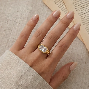 Detailed shot of a vintage gold twist ring with a large rectangular clear stone