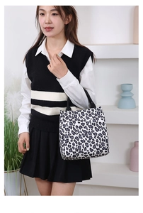 Detail of fashion large capacity tote bag with stylish black and white leopard print