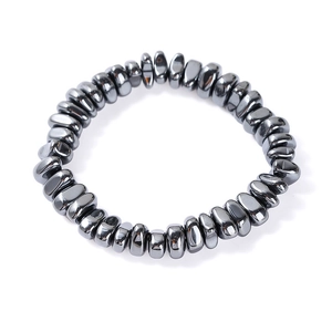 Macro detail of irregular smooth hematite stones on a handcrafted stretch bracelet