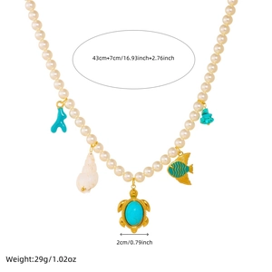 Gold-plated pearl necklace with ocean pendants like sea turtles and shells on white background