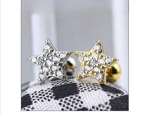 Macro detail of star stud earrings with pavé zircon stones and screw back closure